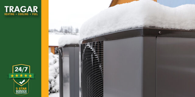 Snow on outdoor HVAC heat pump unit.